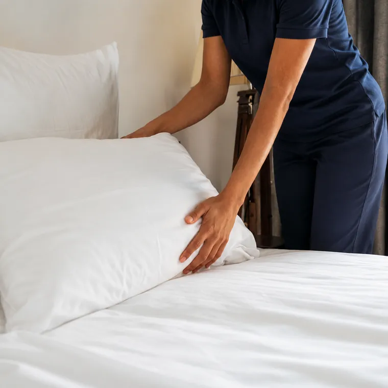 Hospitality housekeeping staff preparing a room